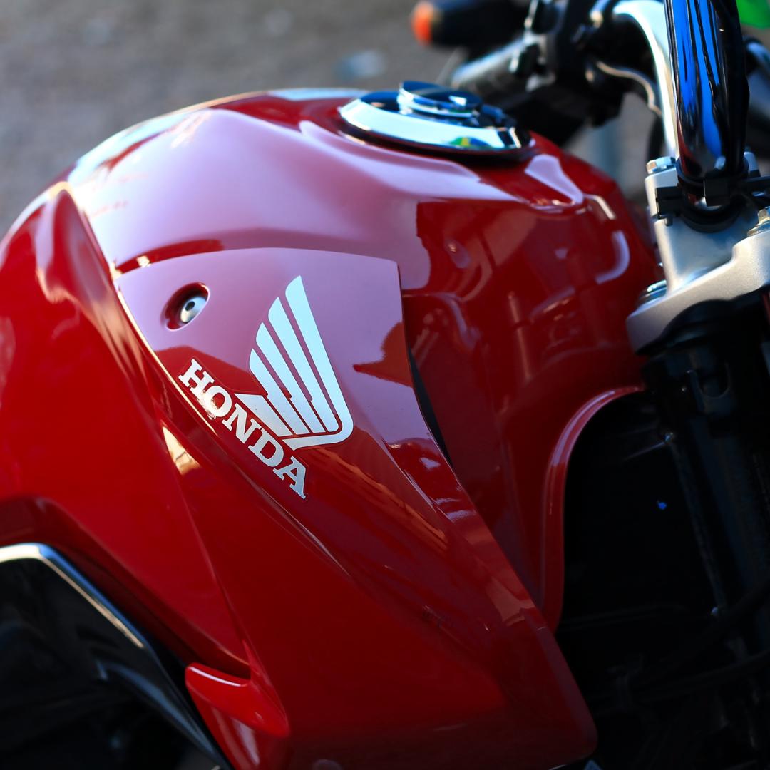 A red motorcycle with the Honda logo, showcasing the history of Honda motorcycles.