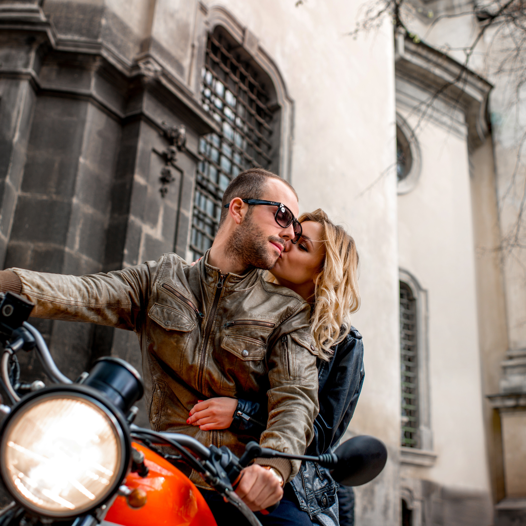 A man and a woman wear helmets as they go on a motorcycle date.